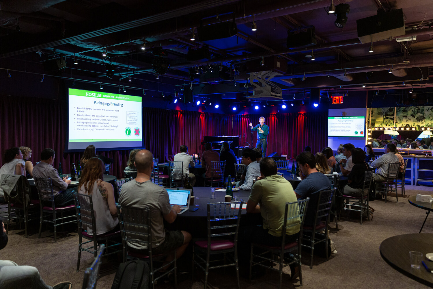 Boot Camp session room with a Packaging Branding slide and attendees at round tables