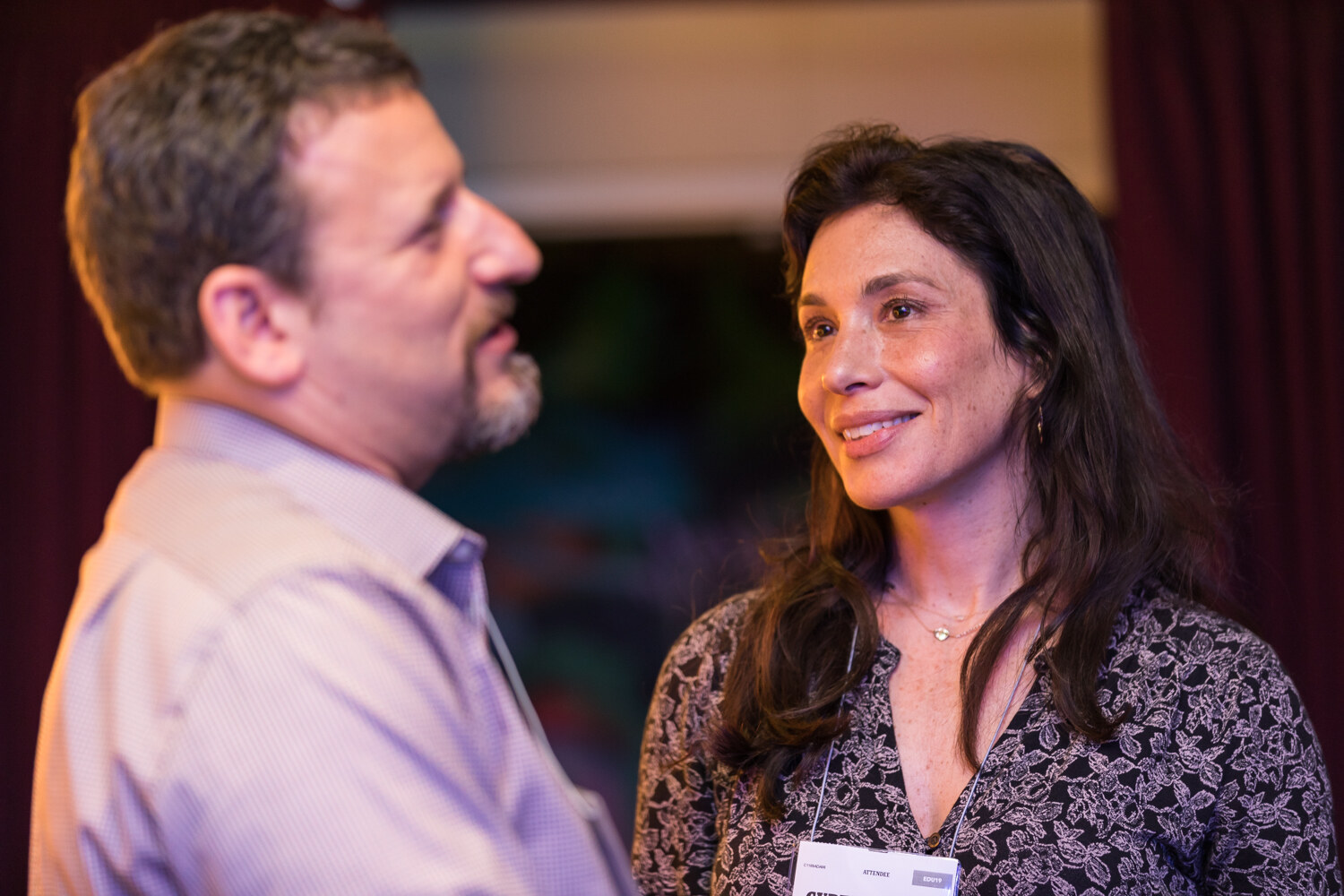 Man and woman smiling in conversation at Boot Camp
