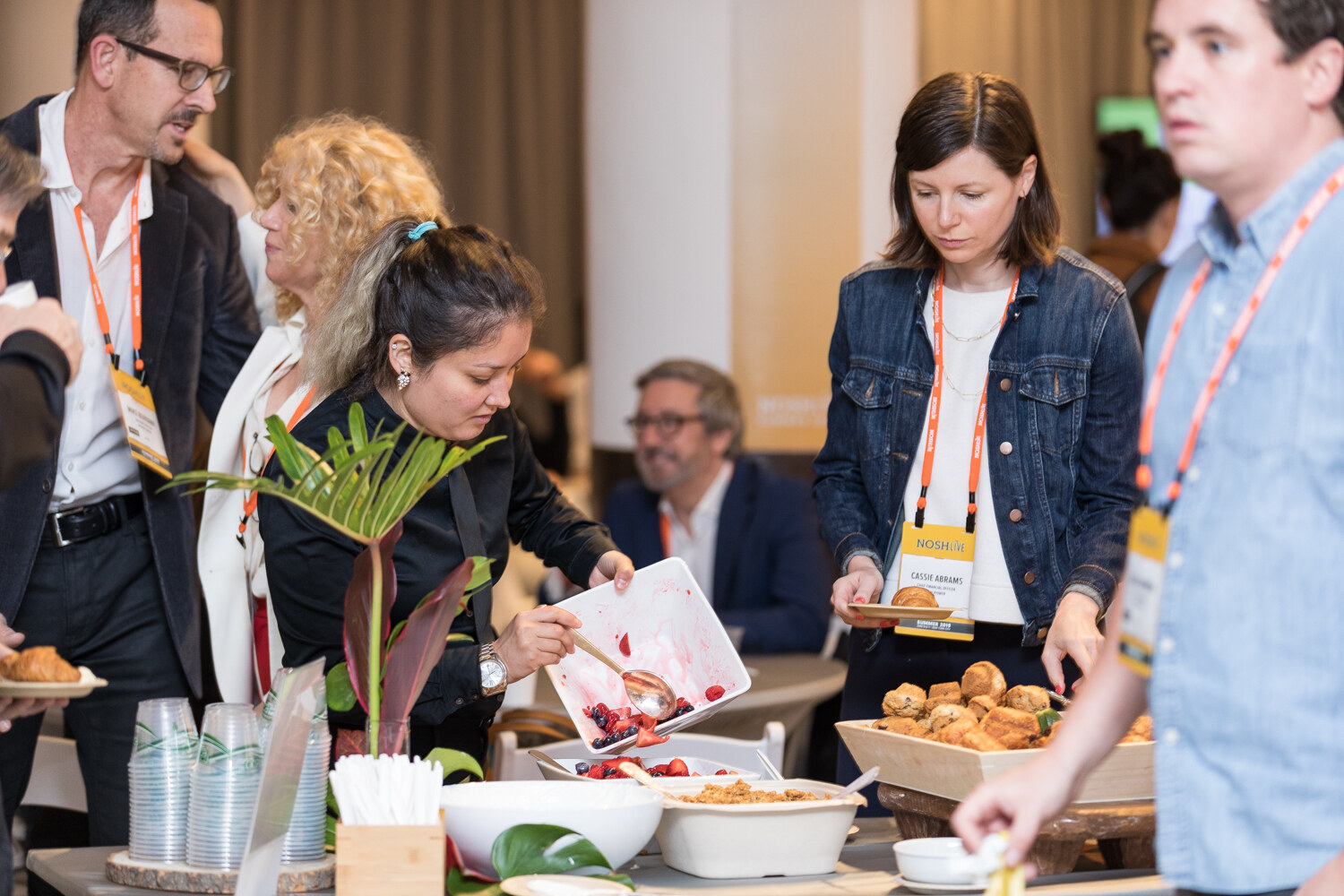 Attendees serving themselves from the breakfast buffet