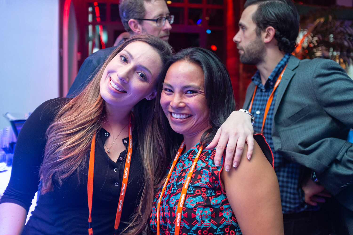 Two women posing cheek to cheek and smiling at the camera
