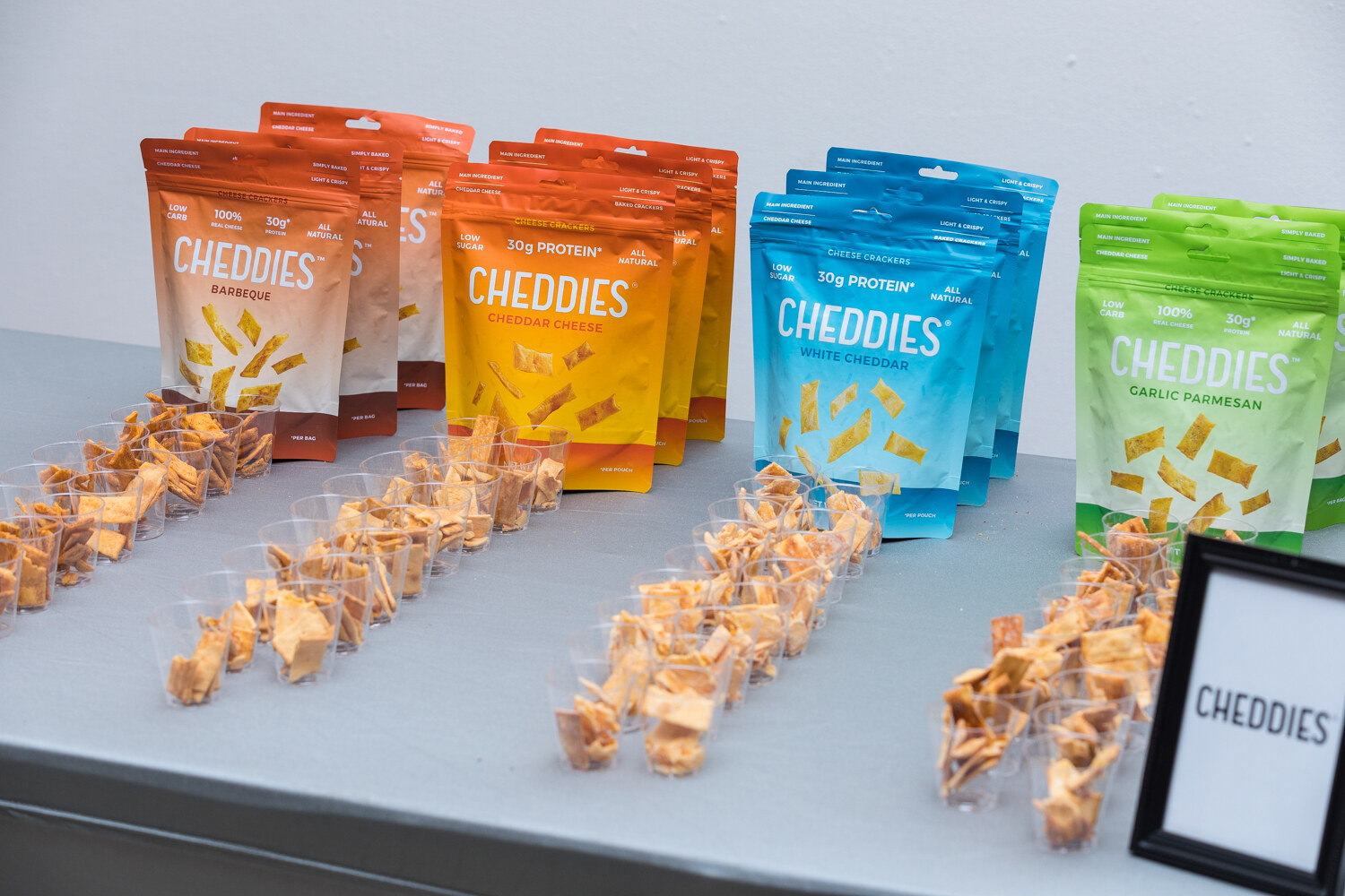 Cheddies pouches with rows of cheese sample cups