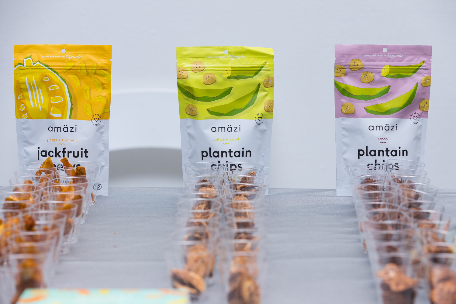 Amazi jackfruit and plantain chips pouches with rows of sample cups