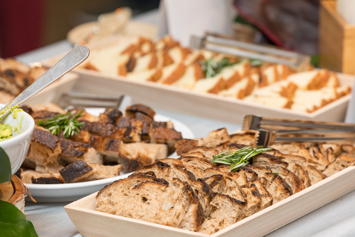 Breakfast spread with sliced bread on a wooden tray