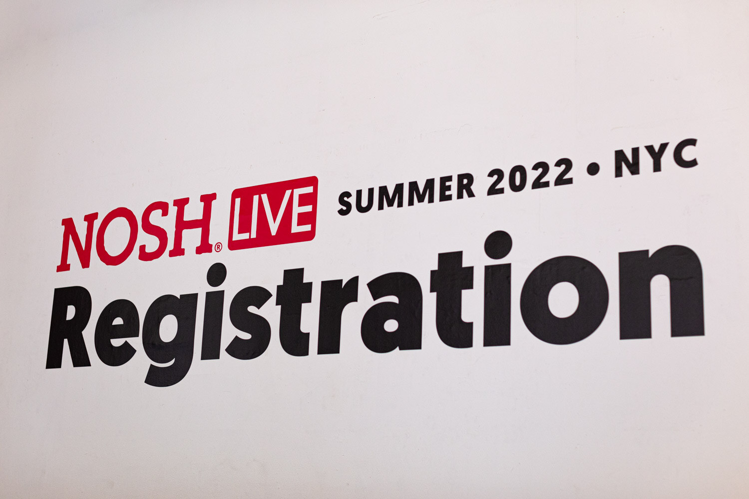 White sign reading Nosh Live Summer 2022 NYC Registration.
