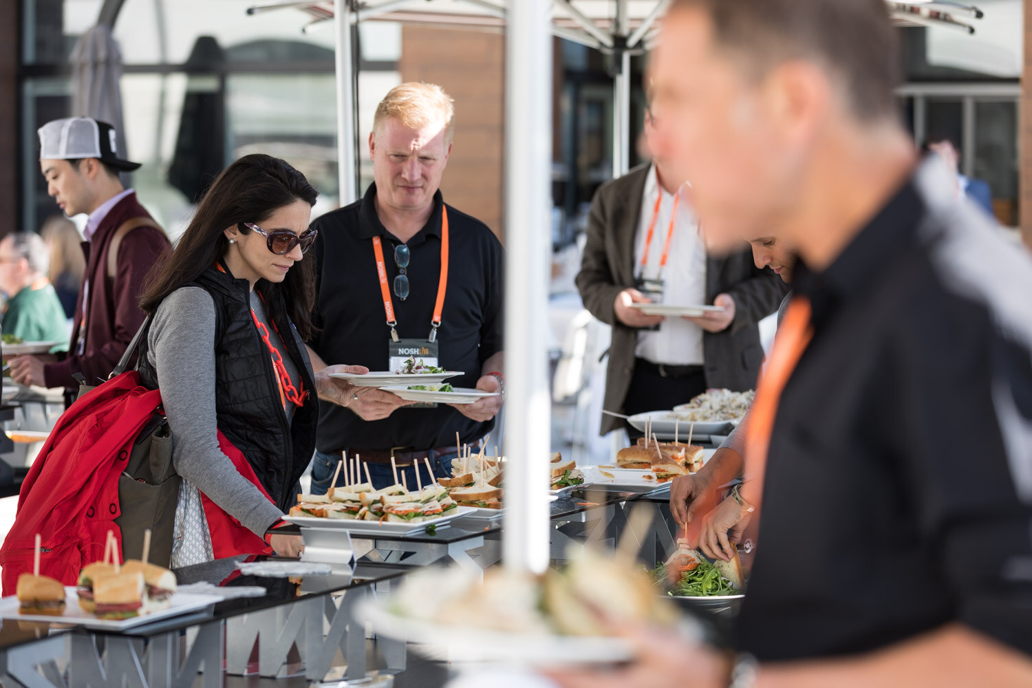 Attendees fill plates at the lunch buffet on the terrace.