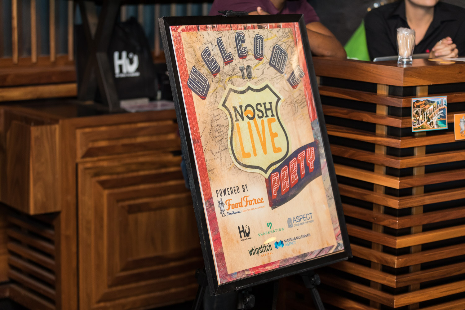 A Welcome to Nosh Live Party sign on an easel at the afterparty.