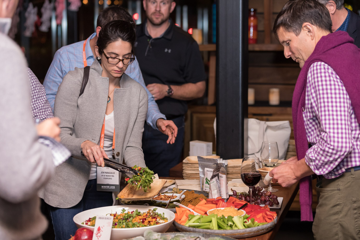 Attendees serve themselves from a food table at the afterparty.