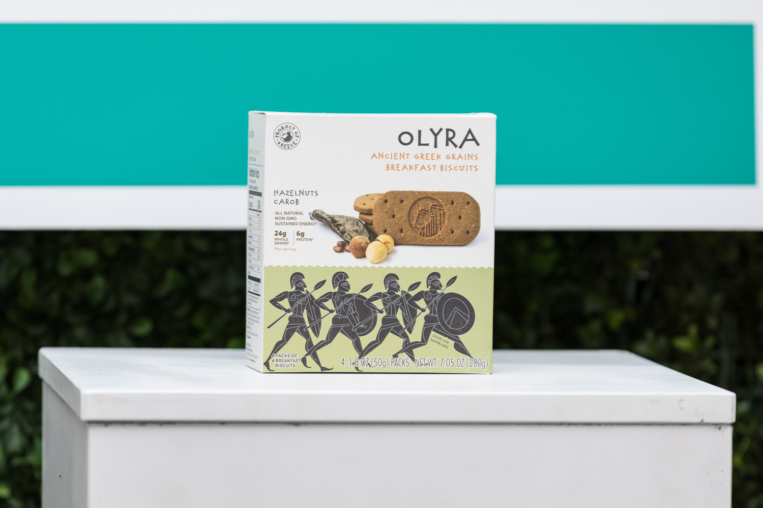 A box of Olyra breakfast biscuits on a white pedestal.