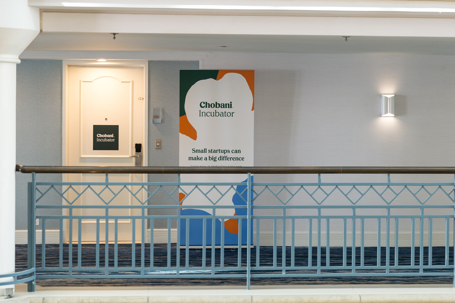 A Chobani Incubator banner on the second-floor railing.