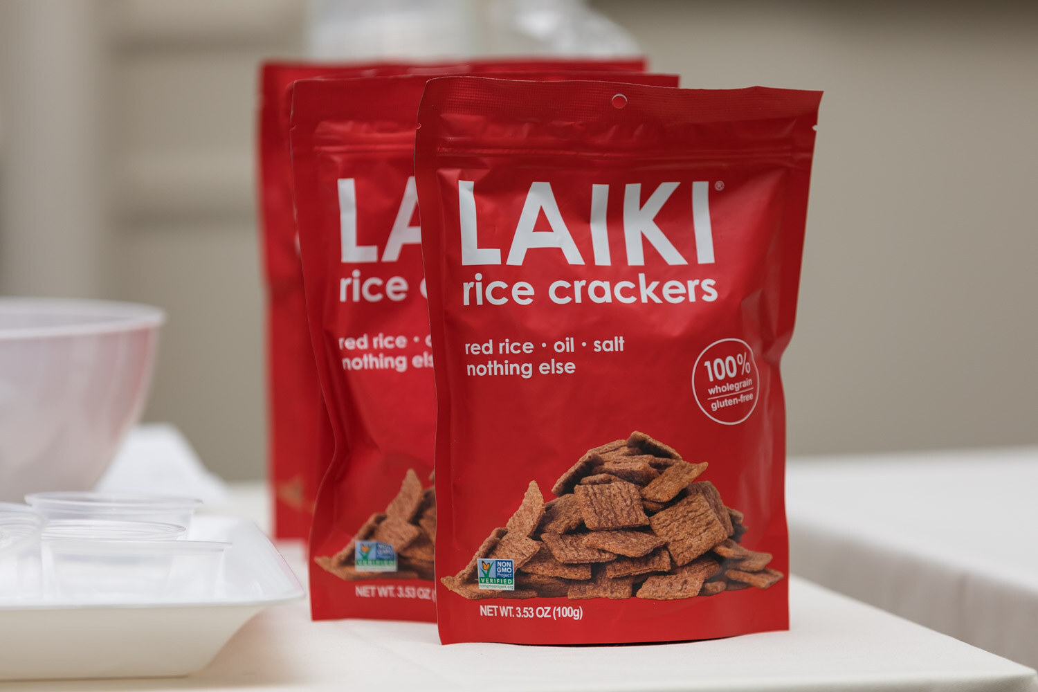 Two red bags of Laiki rice crackers on a table.
