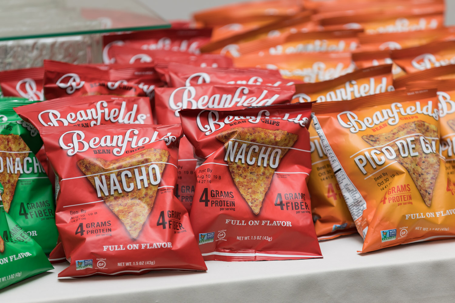 Red bags of Beanfields nacho chips on a display table.