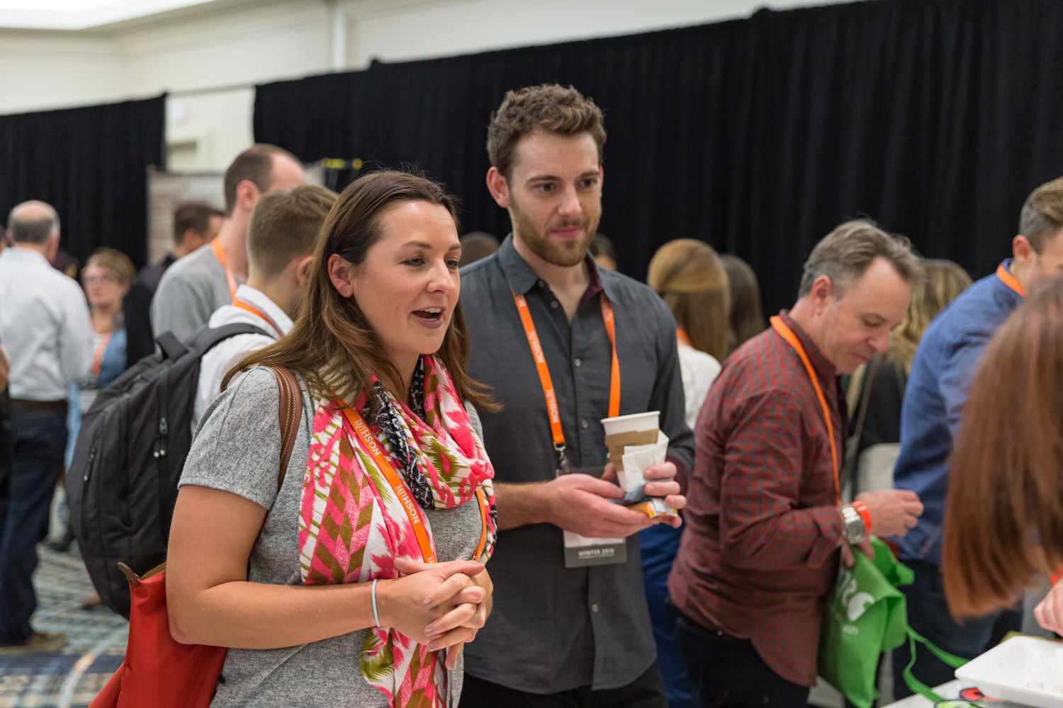 Attendees sample products at an exhibitor table during the Sampling Experience and Expo.