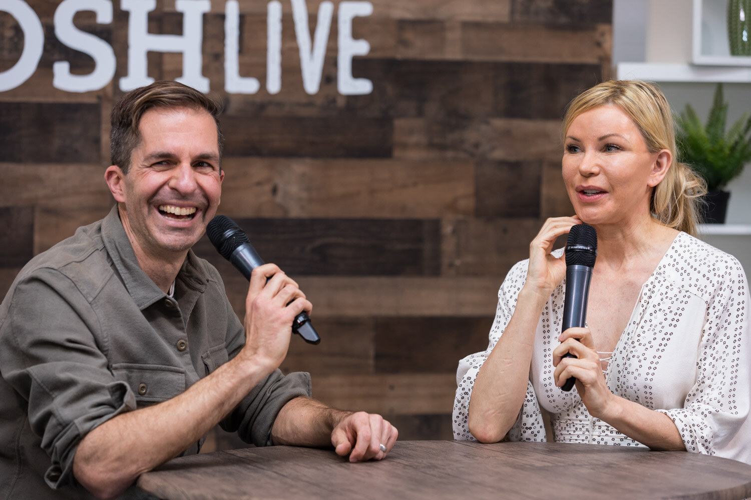 A host laughs while interviewing the Pitch Slam winner in the livestream studio.