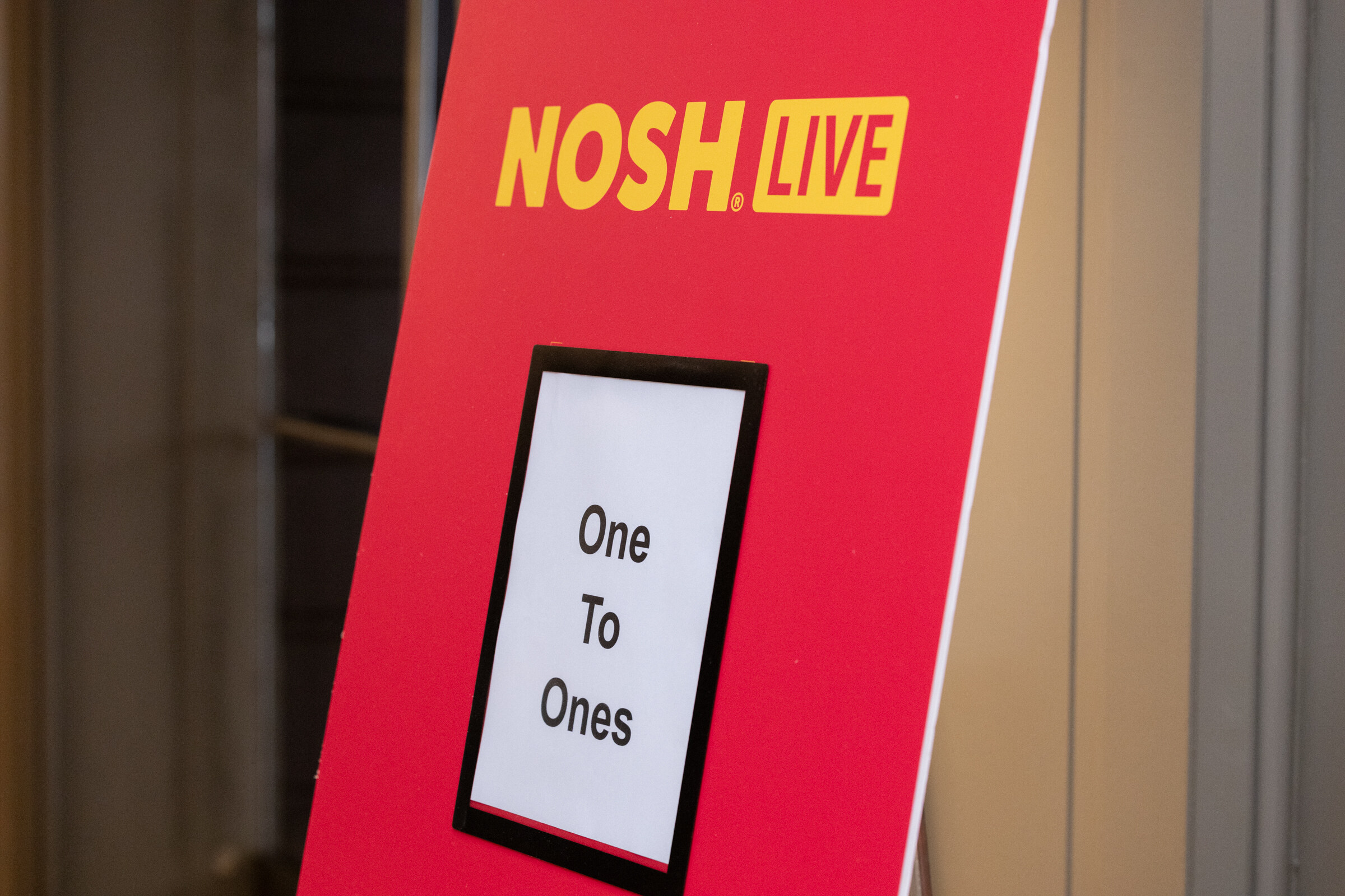 A red Nosh Live sign with a card reading One To Ones.