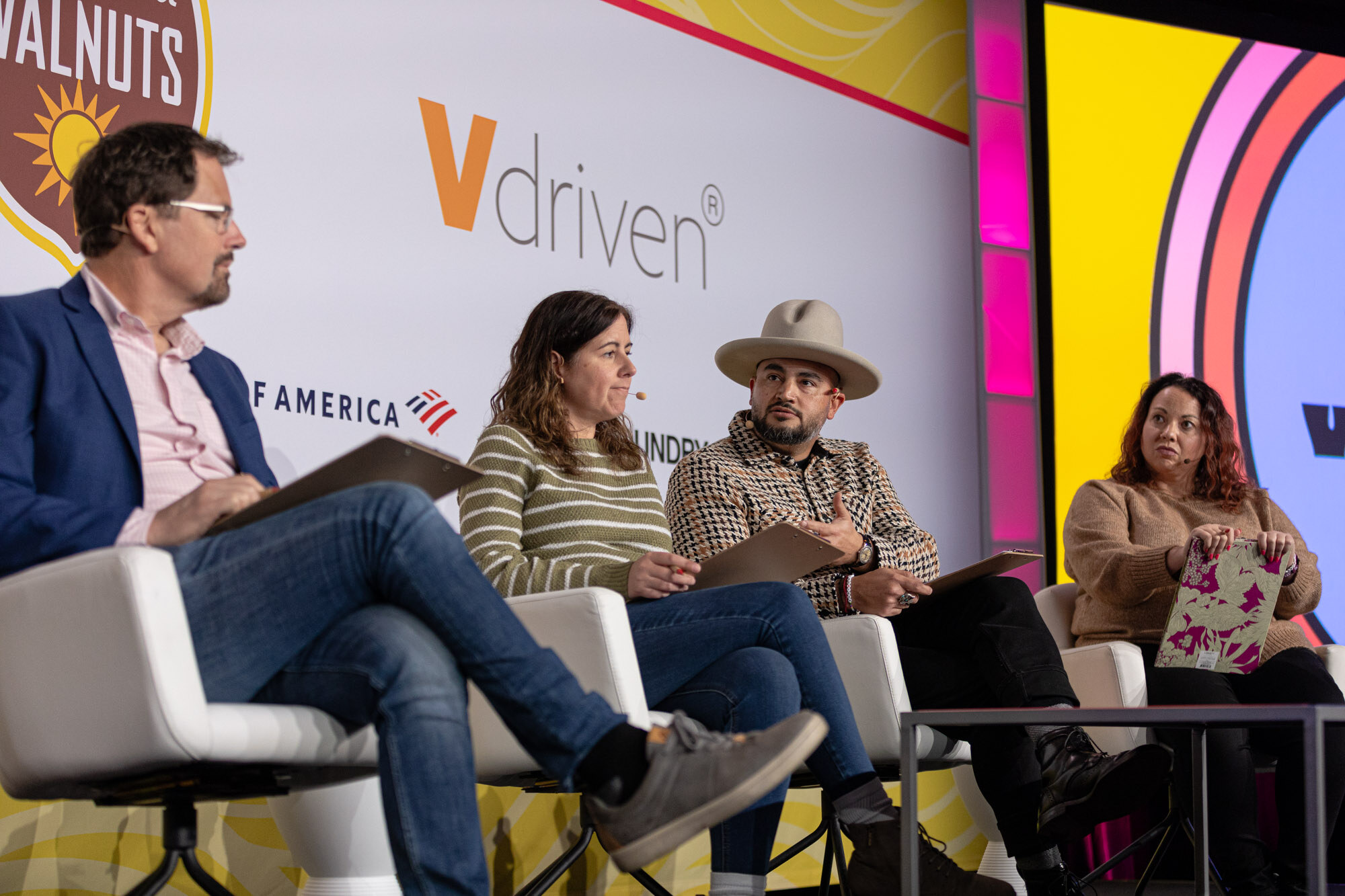 Four judges seated in white chairs in front of the Nosh Live Winter 2024 backdrop.