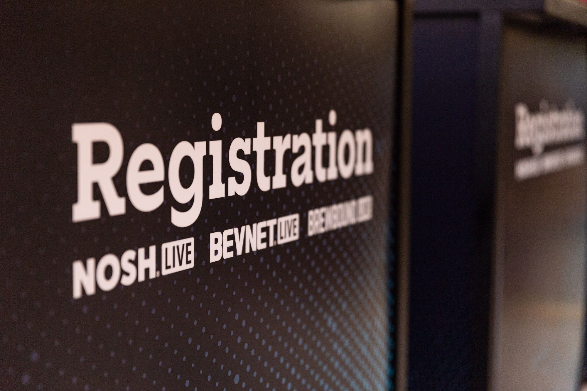 A sign reading Registration with the Nosh Live, BevNET Live and Brewbound Live names.
