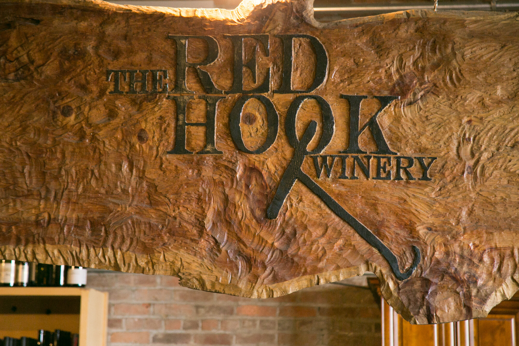 Close view of a carved wooden sign reading The Red Hook Winery.