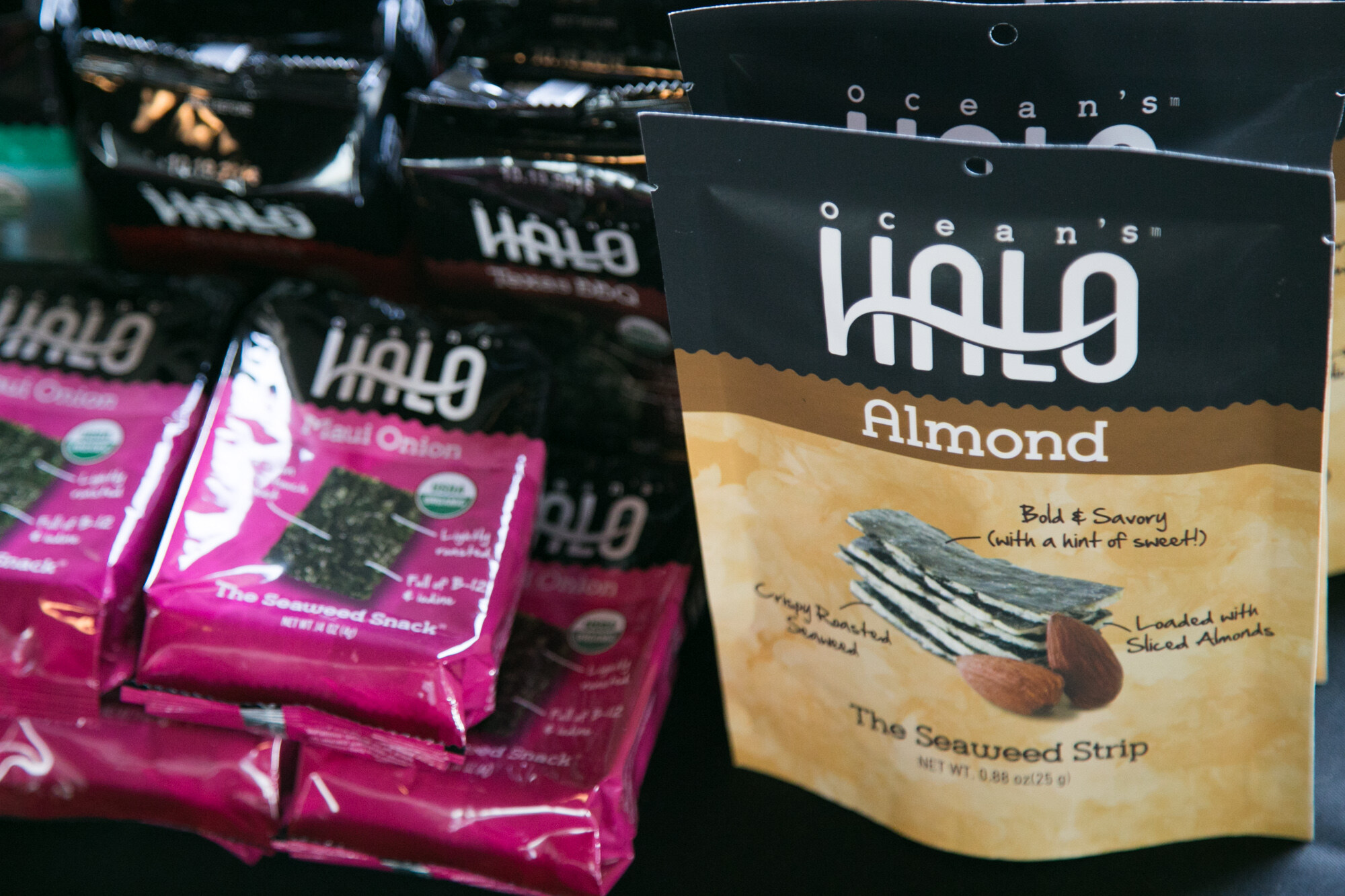 Pink packs of Ocean's Halo Maui Onion seaweed snack beside a bag of Almond seaweed strips.