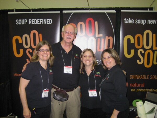 Patti Melcher, Rich Pendergraft and Angela Syzdek of Cool Soup at the Cool Soup booth at NY Fancy Food 2008, with one additional unnamed person.