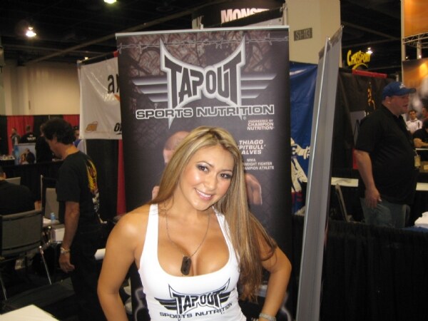 Photo associated with the Tap Out brand at the Olympia 2009 trade show. The photo is unavailable, so no further visual detail is described.