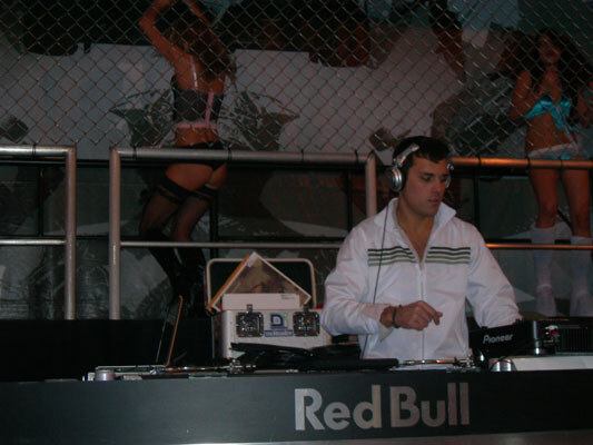 Red Bull has a massive booth feature living a DJ and cage dancers.