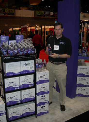 Penta water had its typical stacked case display. Pictured here is East Division Sales Manager Dan Crossan.