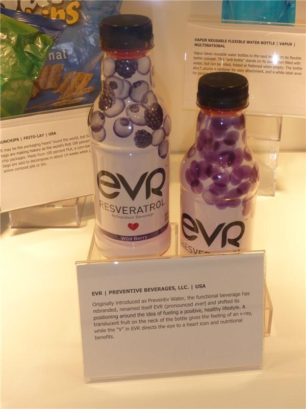 Two EVR Resveratrol antioxidant beverage bottles with fruit imagery sit above a card for EVR by Preventive Beverages, LLC; Frito-Lay and Vapur cards are in the background.