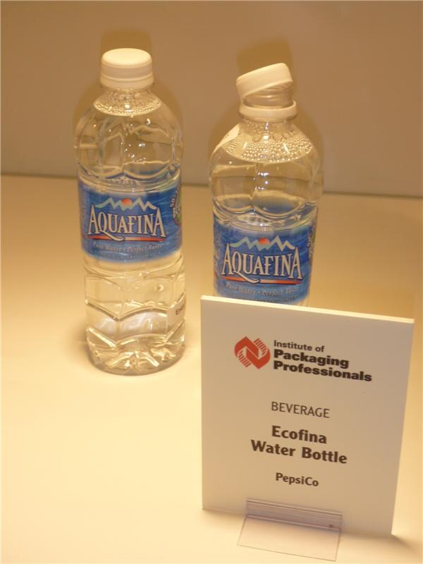 Two Aquafina water bottles, one with its cap tilted off, stand behind an Institute of Packaging Professionals sign reading Beverage, Ecofina Water Bottle, PepsiCo.