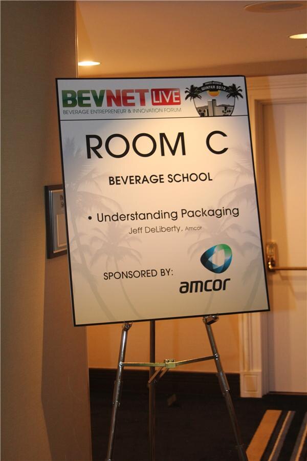 Easel sign for Room C, Beverage School, listing the session Understanding Packaging with an Amcor speaker and a Sponsored by Amcor logo, under the BevNET Live Winter 2010 banner.