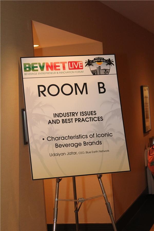 Easel sign for Room B, Industry Issues and Best Practices, listing the session Characteristics of Iconic Beverage Brands with a speaker from Blue Earth Network, on a BevNET Live Winter 2010 banner.