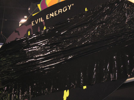 A display with Evil Energy lettering at the top is mostly covered in black plastic wrap, with bits of yellow graphics showing at the bottom.