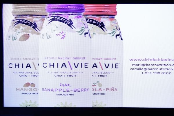 A projected slide showing three Chiavie chia and fruit smoothie bottles in Mango, Banapple-Berry and Cola-Piña flavors, with a website and contact details on the right.
