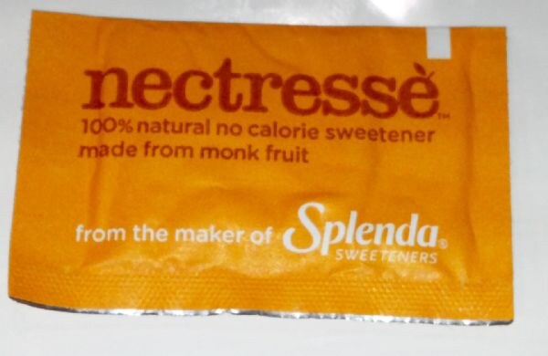 A single orange Nectresse packet reading 100% natural no calorie sweetener made from monk fruit, with the text from the maker of Splenda Sweeteners.