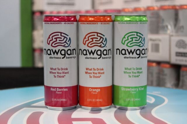 Three nawgan alertness beverage cans in Red Berries, Orange and Strawberry Kiwi flavors stand on a table with a colorful logo design.