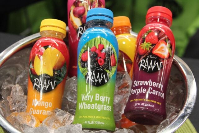 Raaw juice bottles, including Very Berry Wheatgrass, Strawberry Purple Carrot and Mango Guarana, sit in a metal bowl of ice.