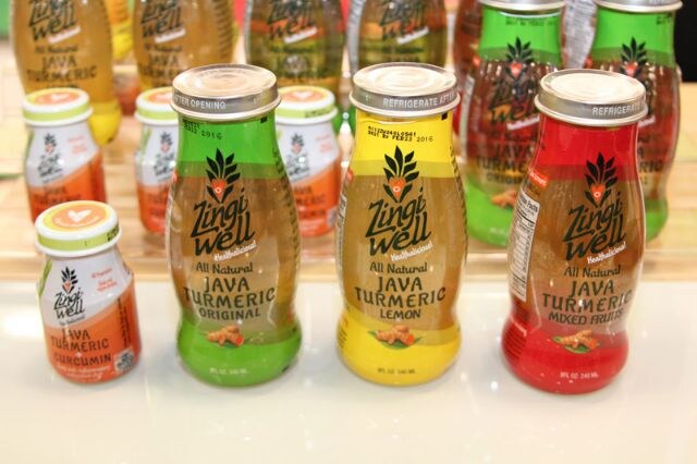 ZingiWell Java Turmeric bottles in Original, Lemon and Mixed Fruits varieties, with a smaller Curcumin bottle at left and more bottles blurred behind.