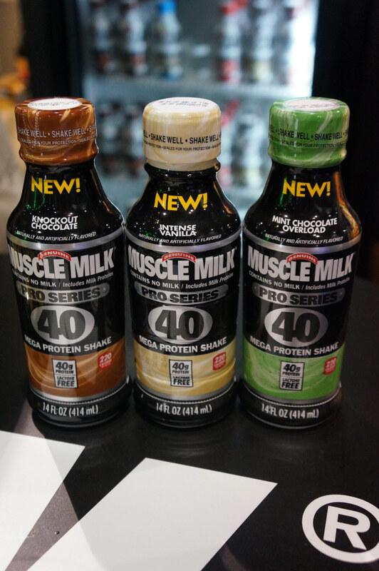 Three bottles of Muscle Milk Pro Series 40 protein shake in Knockout Chocolate, Intense Vanilla and Mint Chocolate Overload, each marked New, on a black table.