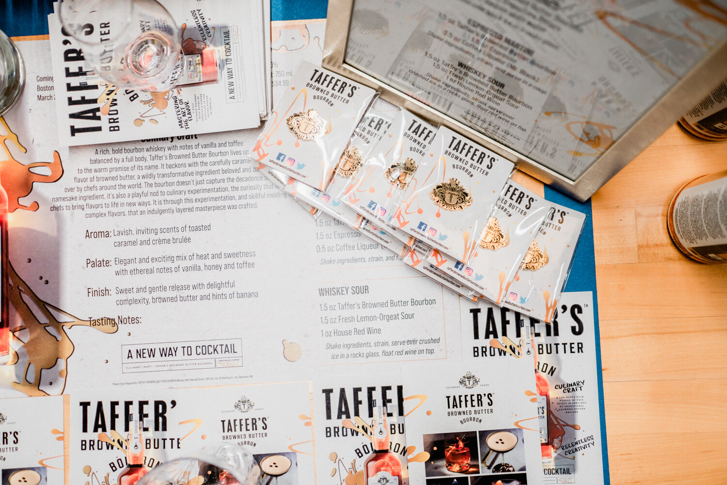 Overhead view of printed menus and sample packets for Taffer's Browned Butter Bourbon.