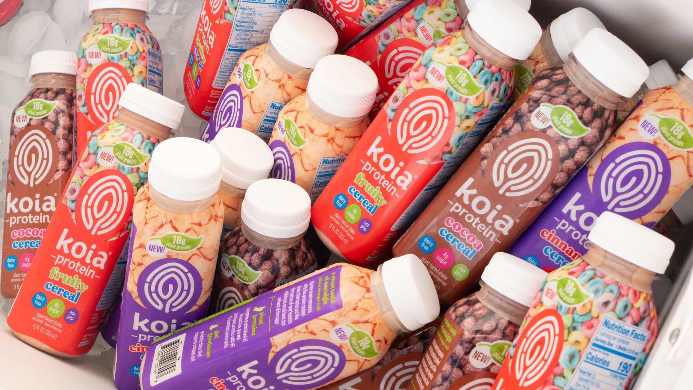 Overhead view of Koia protein drink bottles in cereal flavors inside a white cooler.