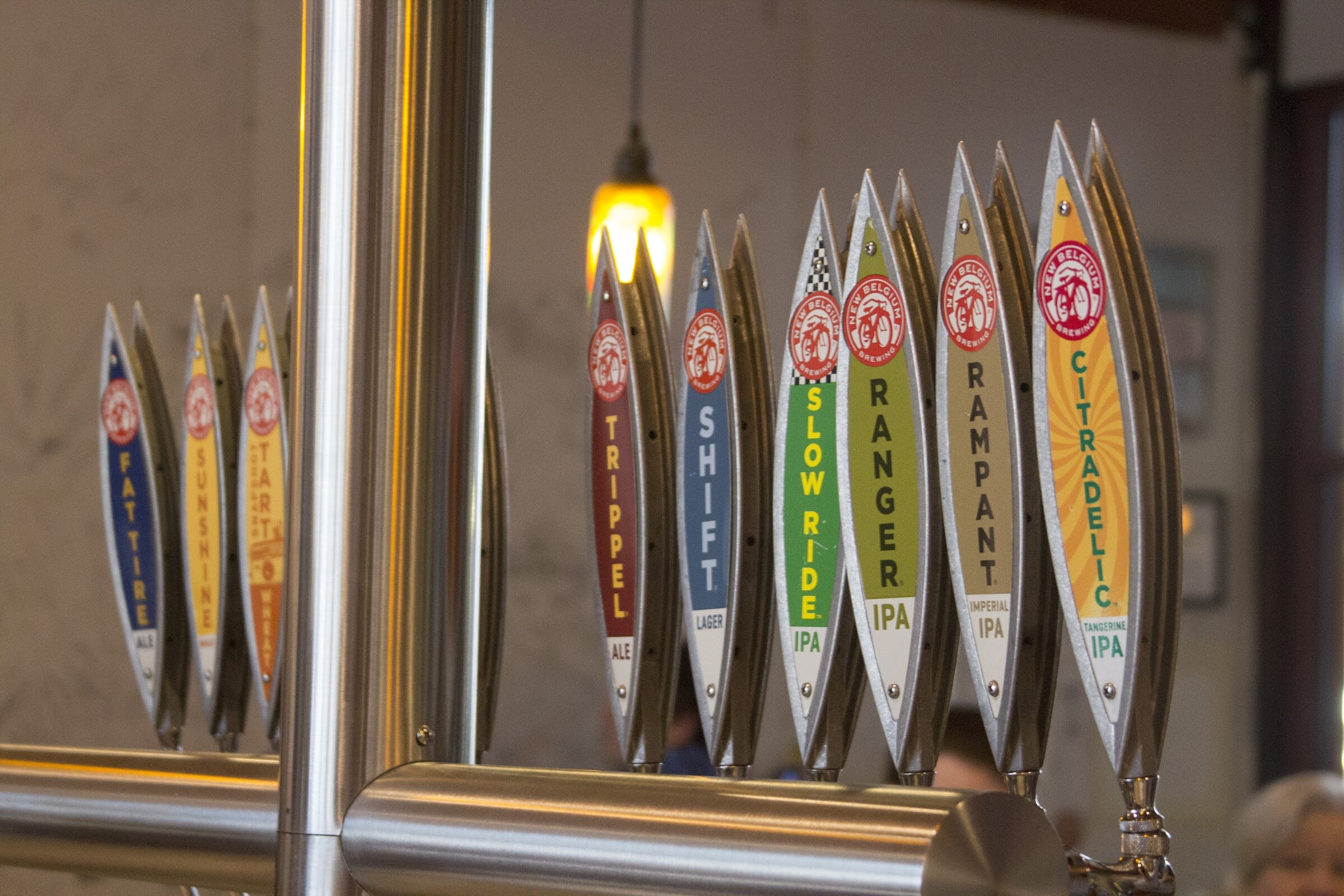 A row of pointed silver tap handles carries colorful labels including Tripel, Shift, Slow Ride, Ranger, Rampant and Citradelic.