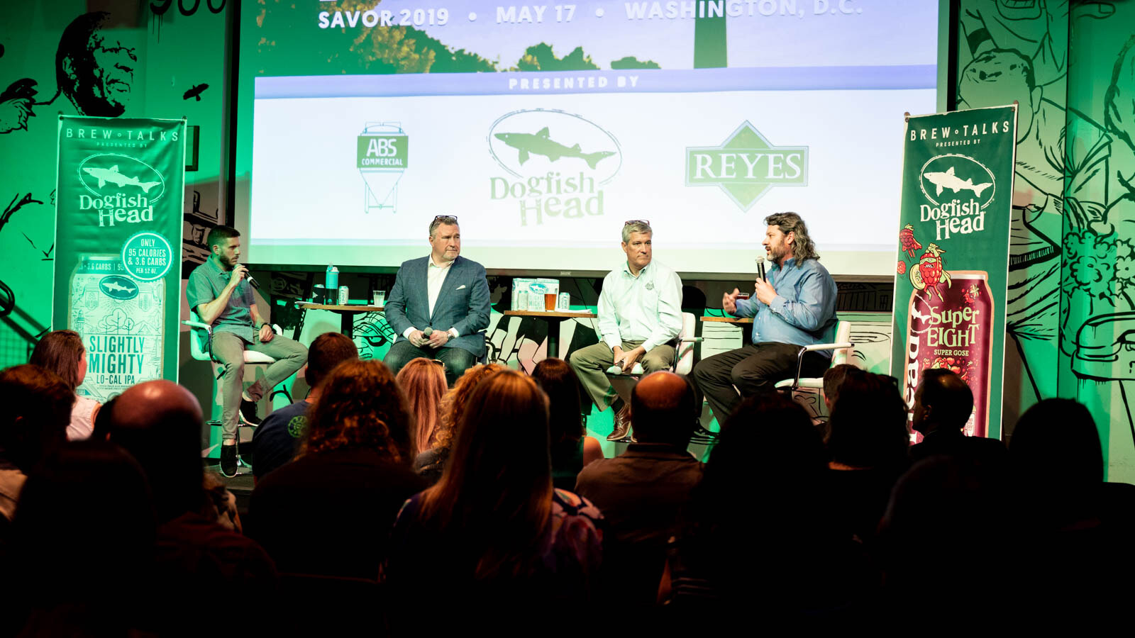 Stage with four panelists, a screen reading SAVOR 2019 May 17 Washington D.C., Brew Talks banners and a seated audience.