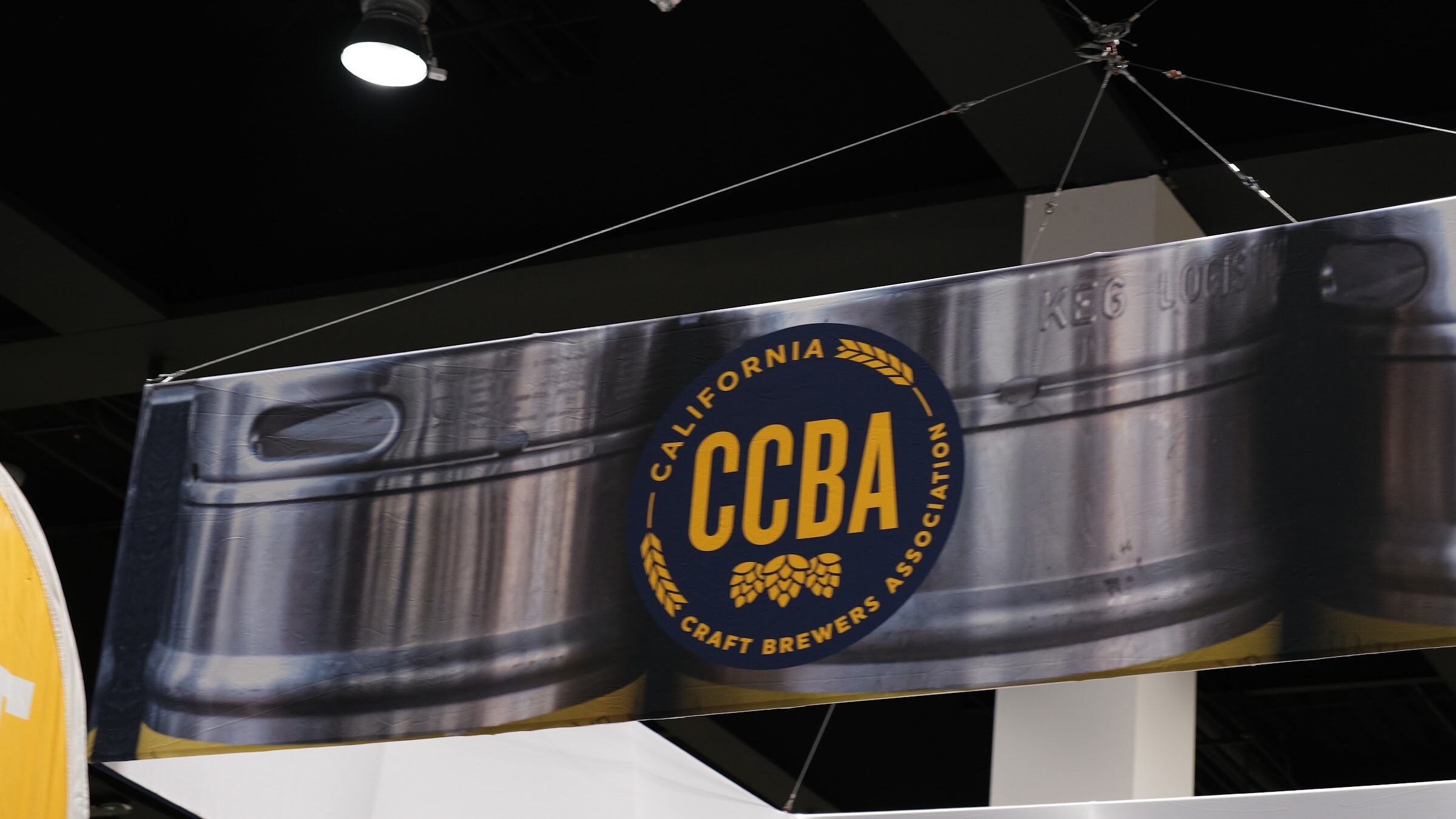 A hanging sign shaped like a keg with the California Craft Brewers Association CCBA logo