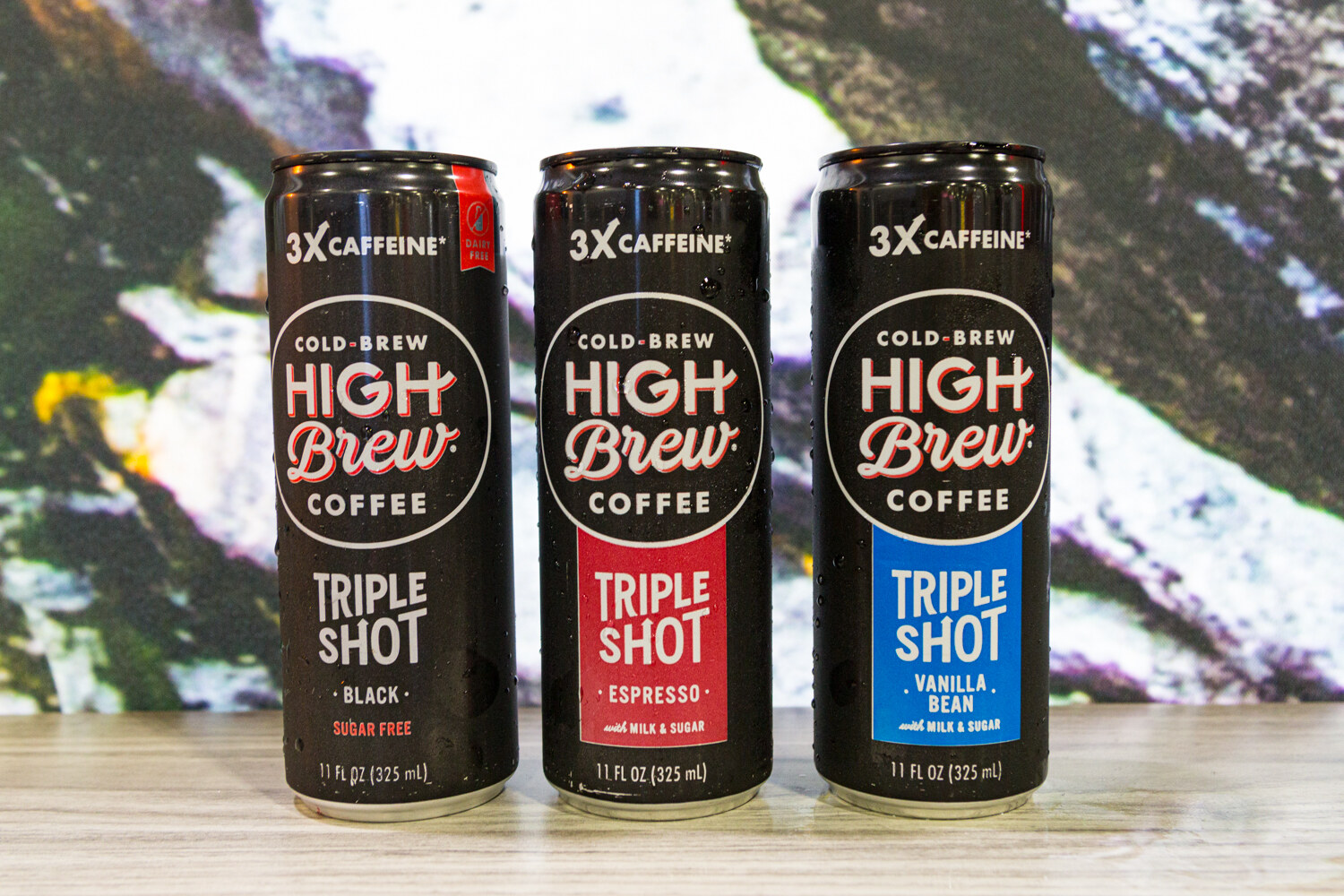Three black High Brew cans labeled Triple Shot in black, espresso and vanilla bean.