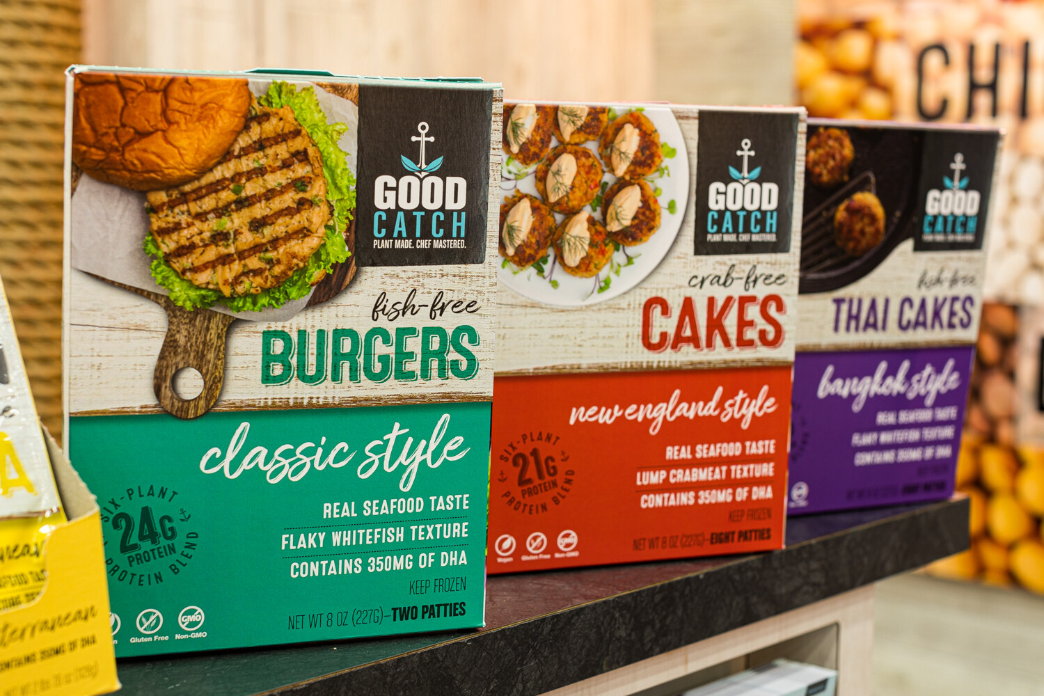 Boxes of Good Catch plant-based Burgers, Cakes and Thai Cakes on a counter.