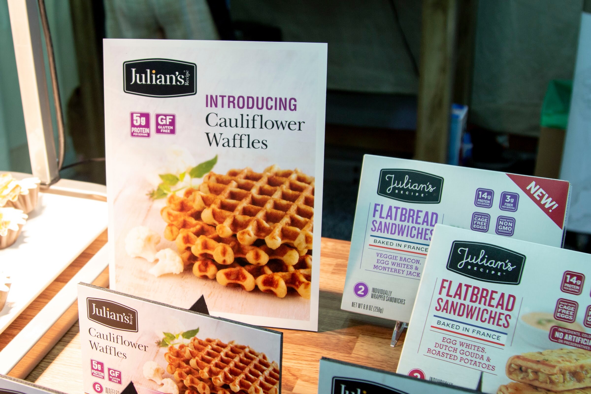 Signs and boxes for Julian's Recipe Cauliflower Waffles and Flatbread Sandwiches.