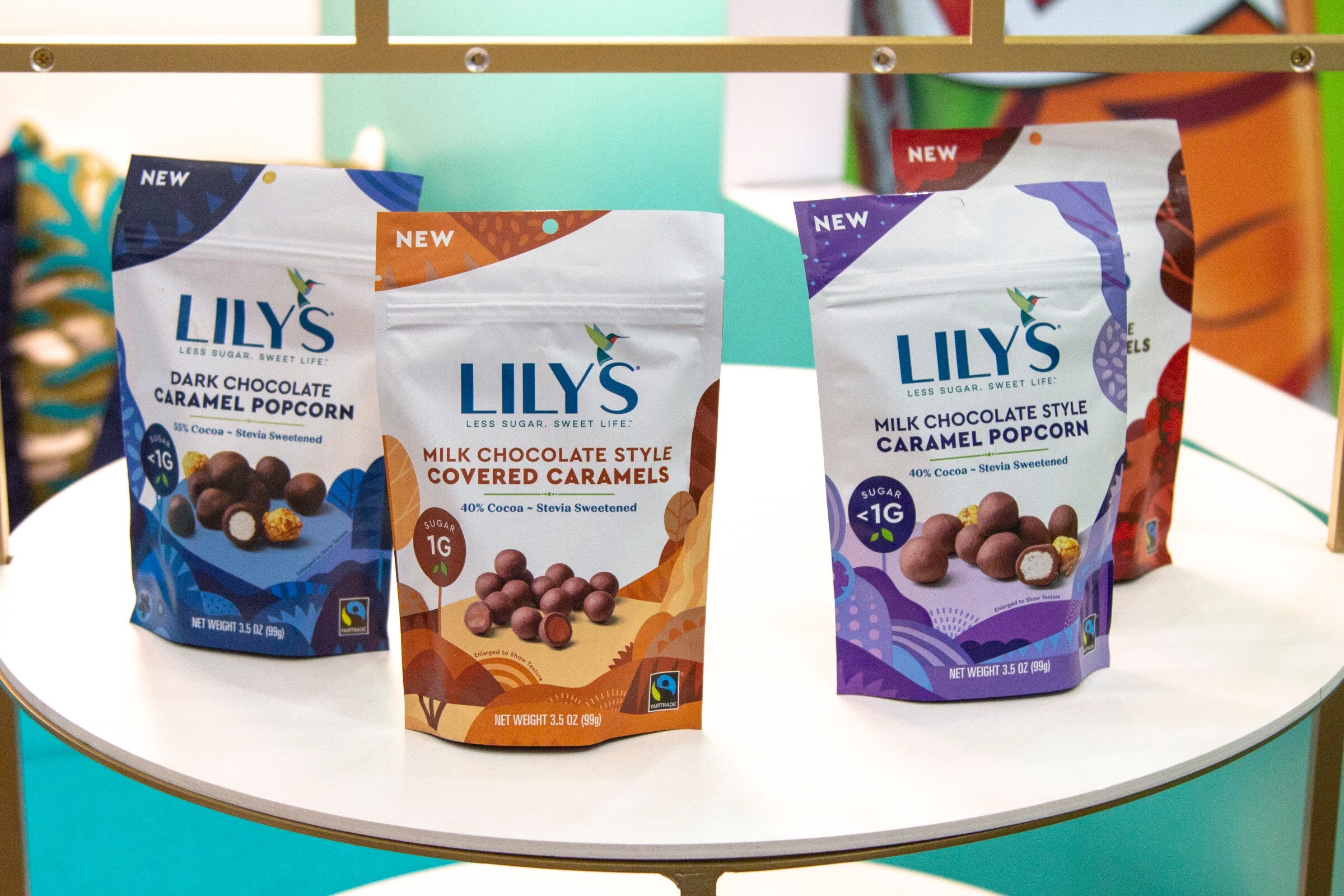 Three Lily's bags in dark chocolate caramel popcorn, milk chocolate covered caramels and milk chocolate caramel popcorn.