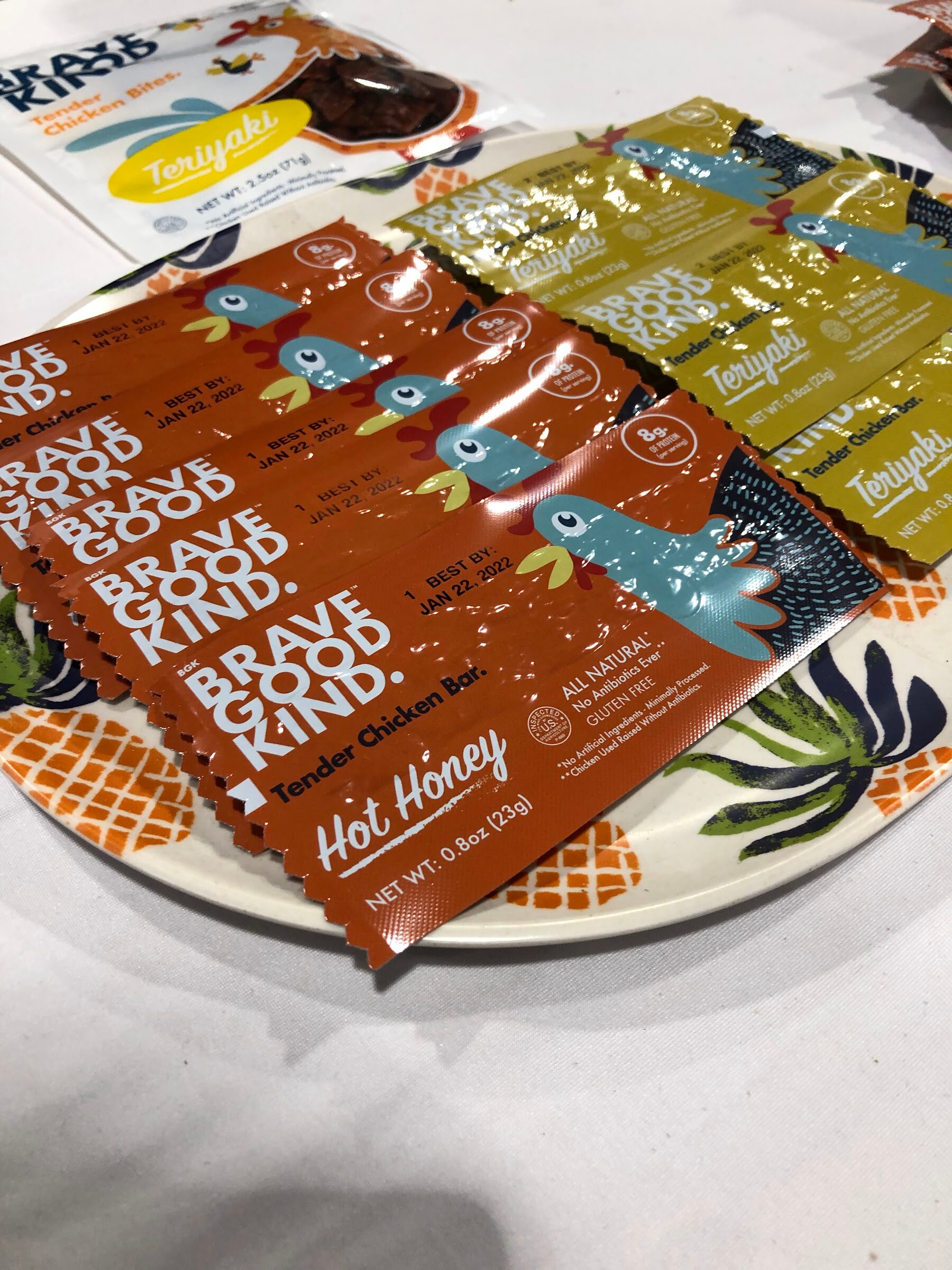 Hot Honey and Teriyaki Brave Good Kind tender chicken bars laid out on a patterned plate