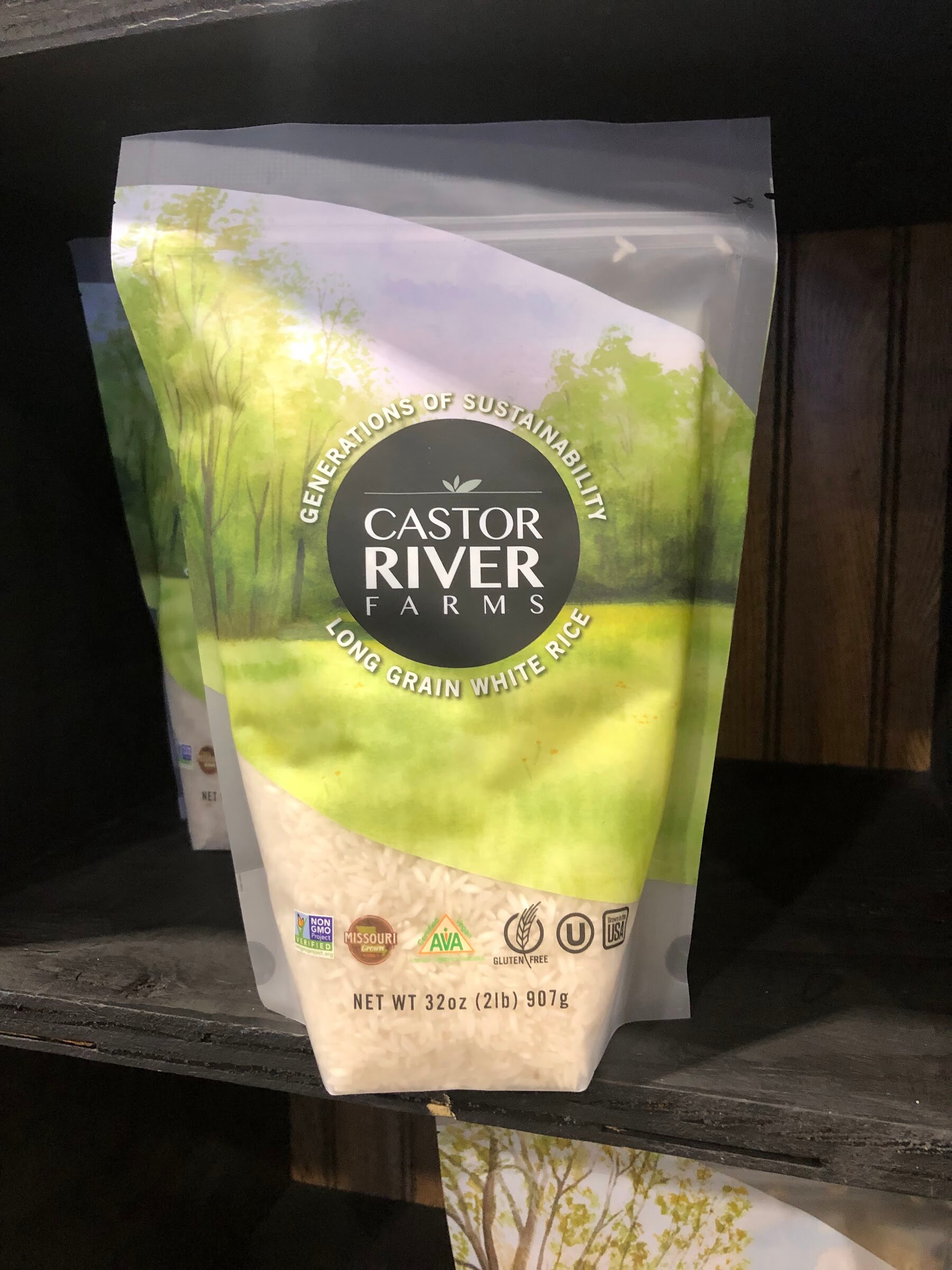 A bag of Castor River Farms long grain white rice on a dark wooden shelf
