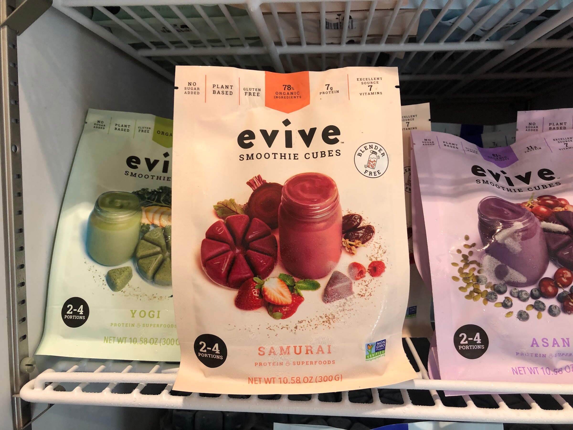 A bag of evive Samurai smoothie cubes in a freezer case beside other evive flavors