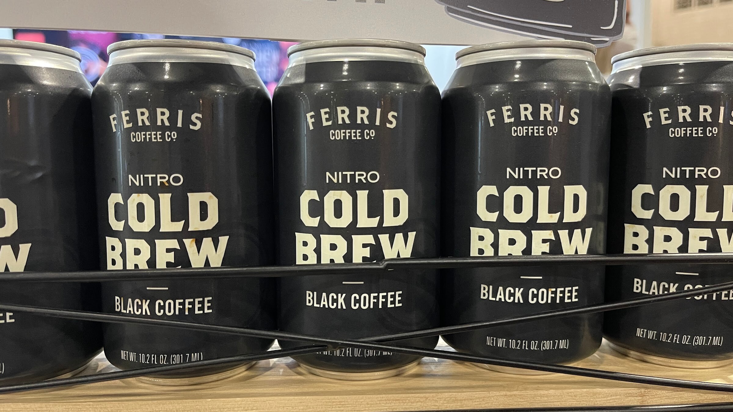 Black Ferris Coffee Co. nitro cold brew cans in a row on a shelf